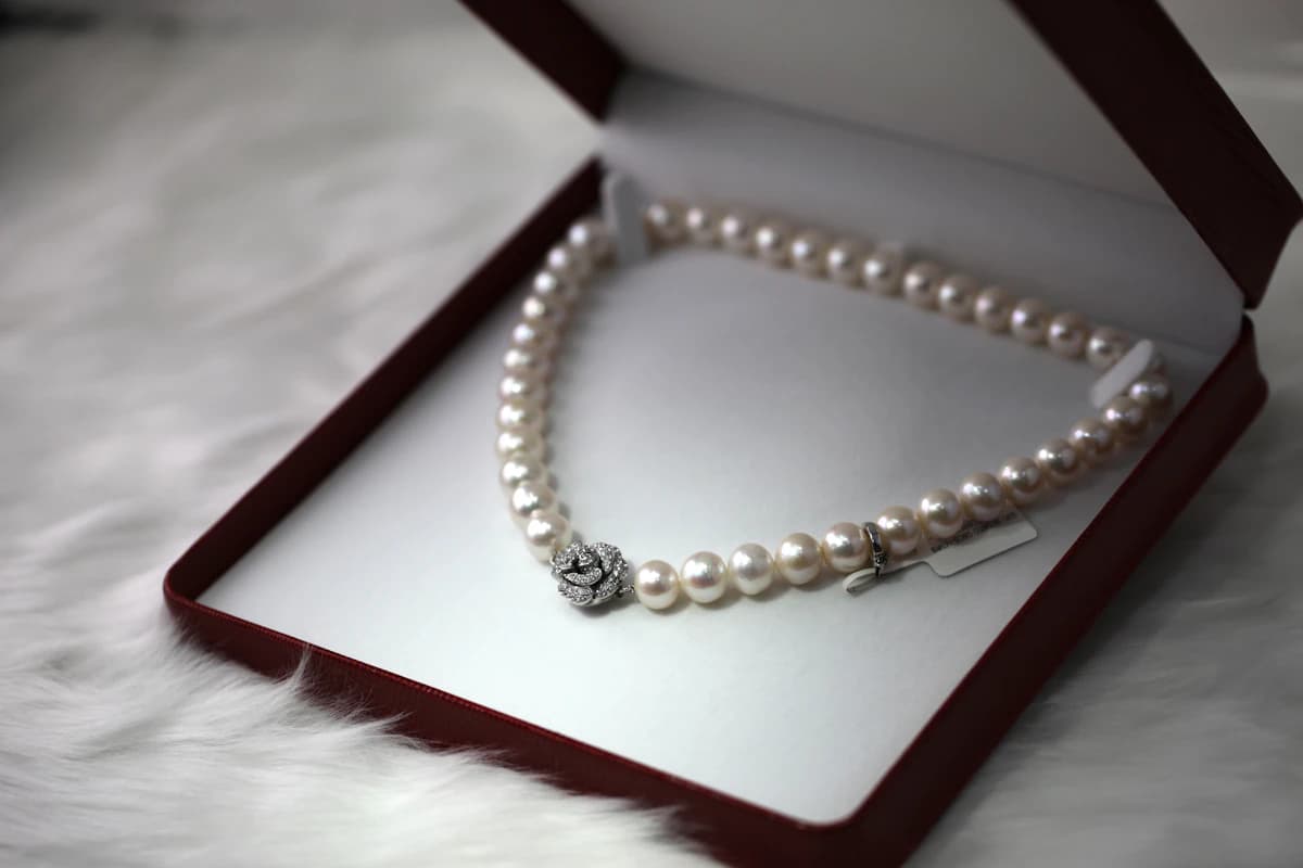 A delicate necklace in a gift box as an example of jewelry chosen to match her existing style